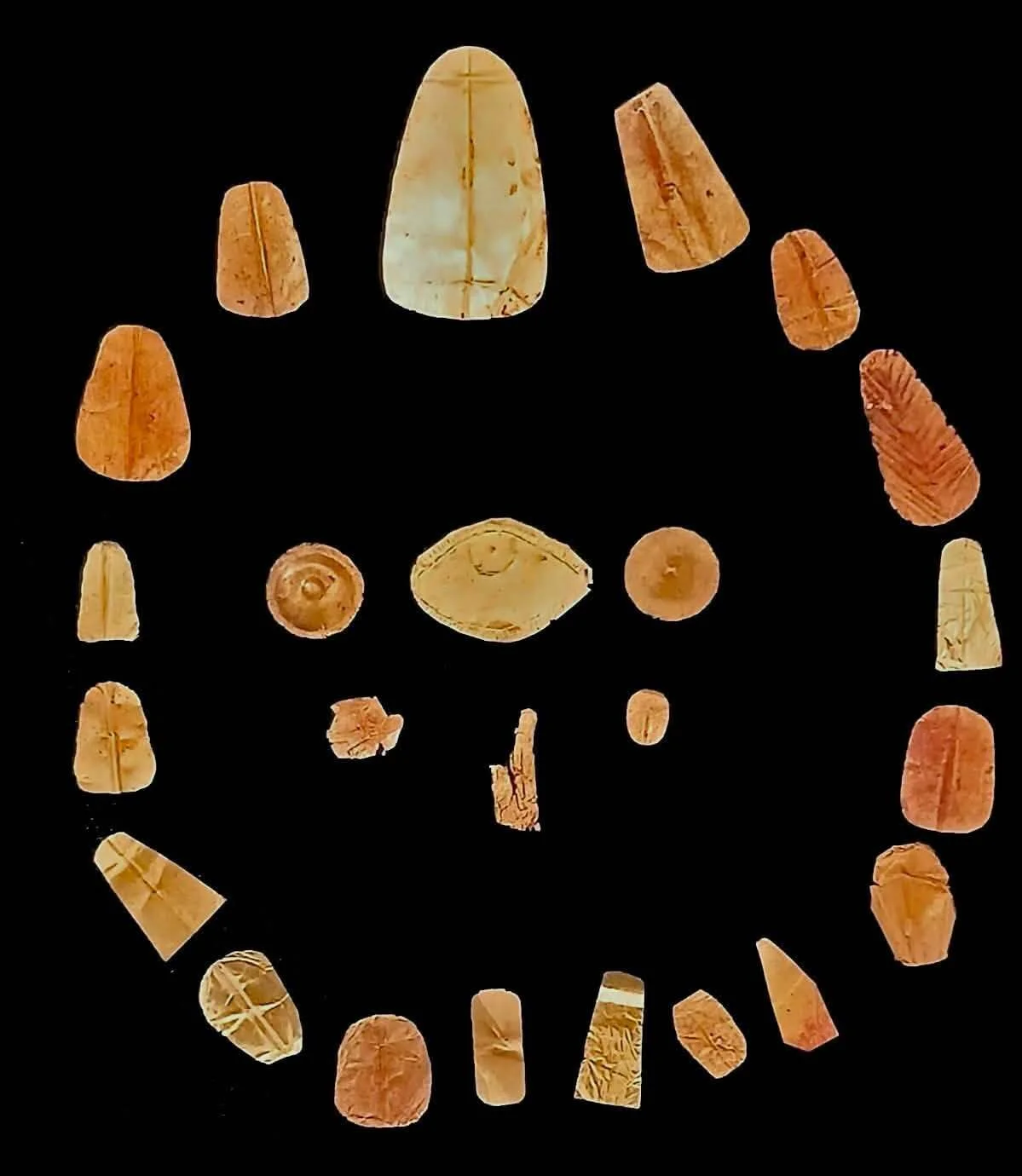A series of golden objects against a dark background.